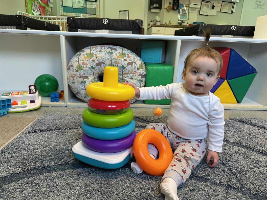 infant playing with toys
